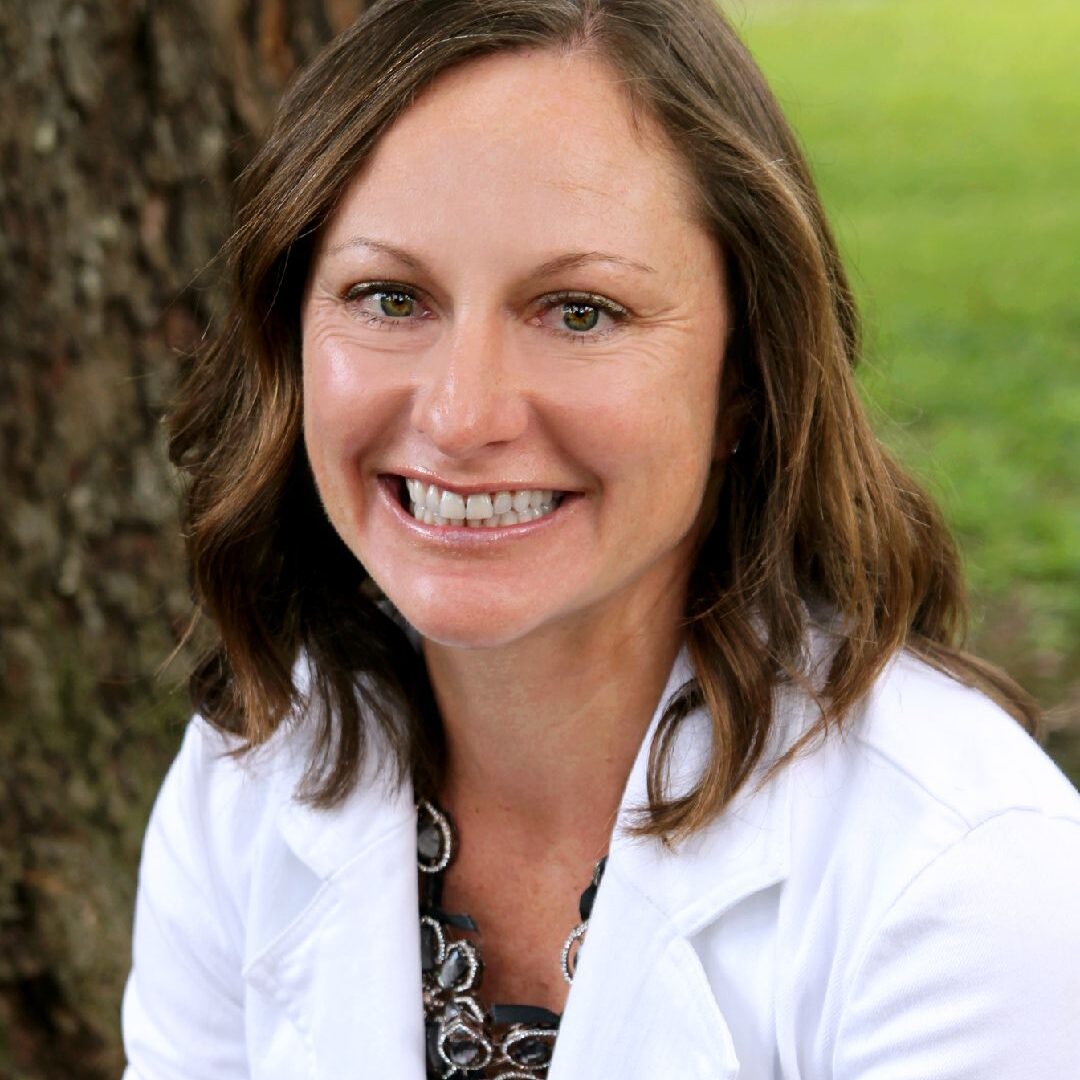 A person wearing a white medical coat